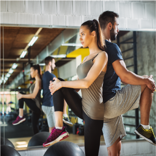 stretching in front of a gym mirror